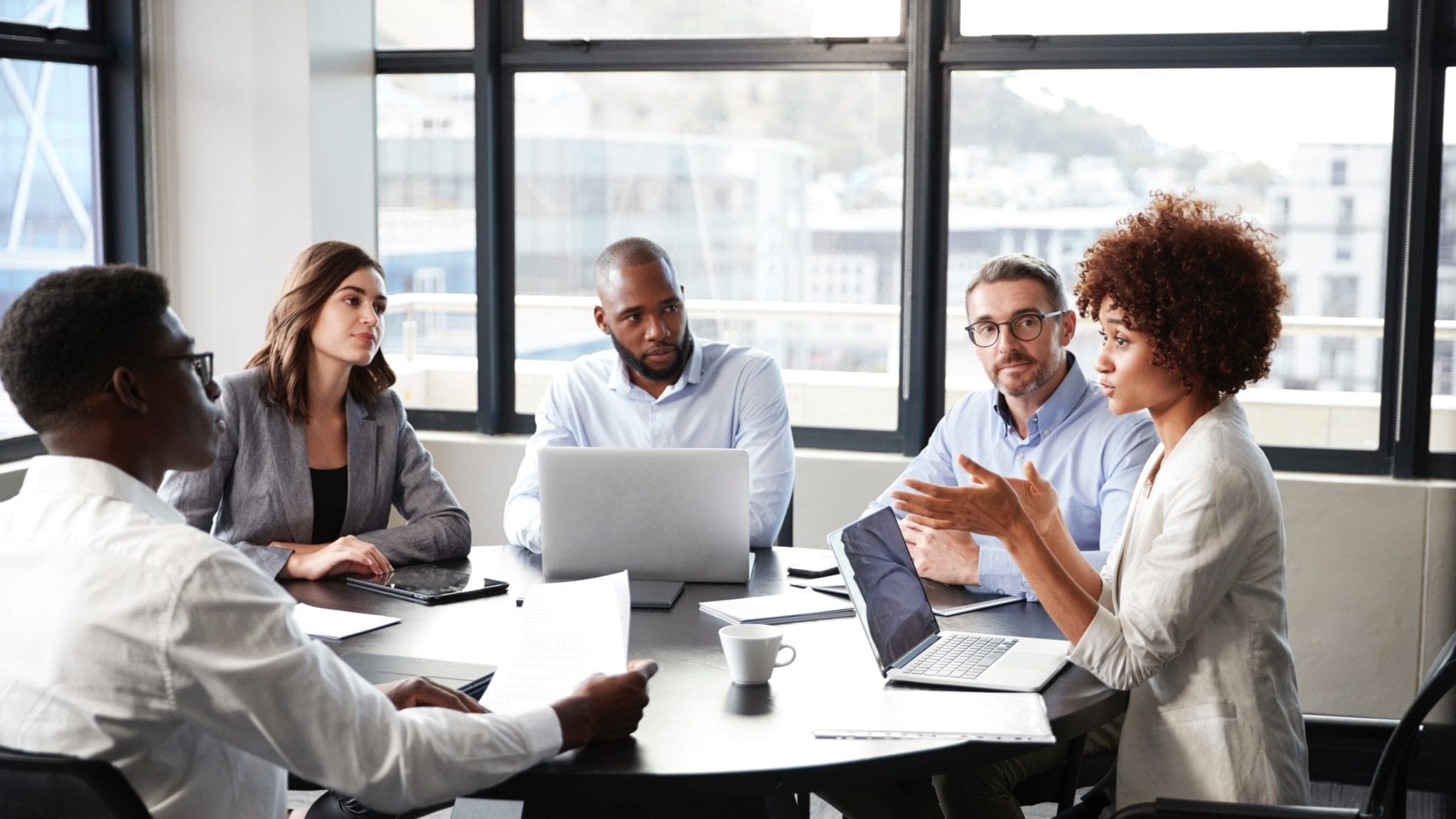 Fiduciary-liability-2 group of men and women around a desk