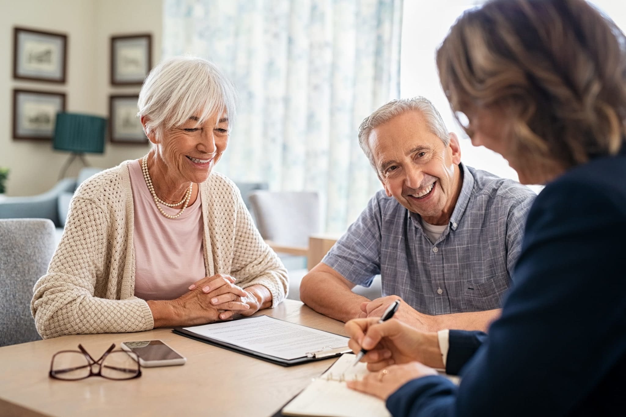 GettyImages-1316202262 Happy Senior Couple Talking to Consultant