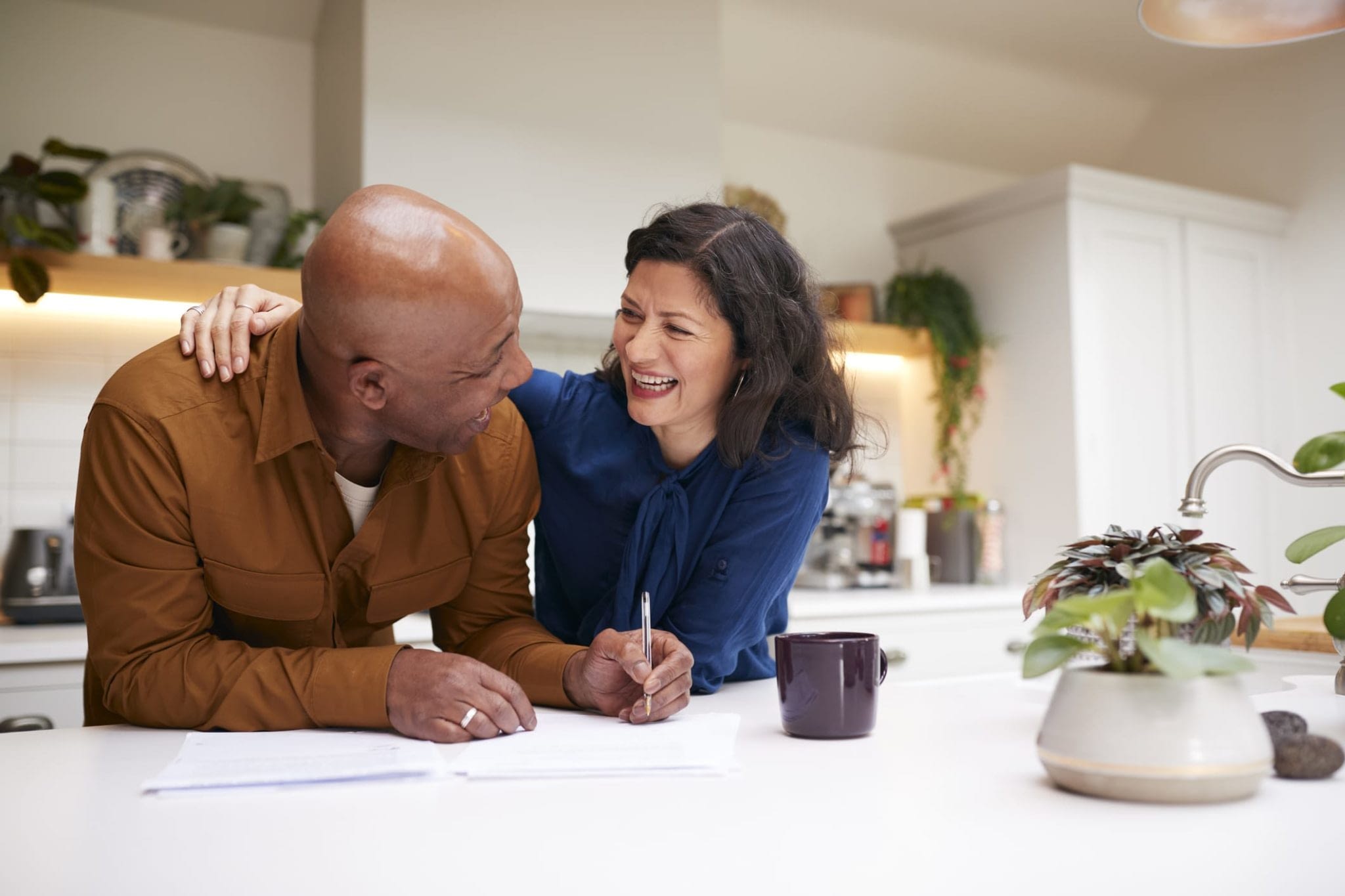 Smiling Mature Couple Signing Paperwork