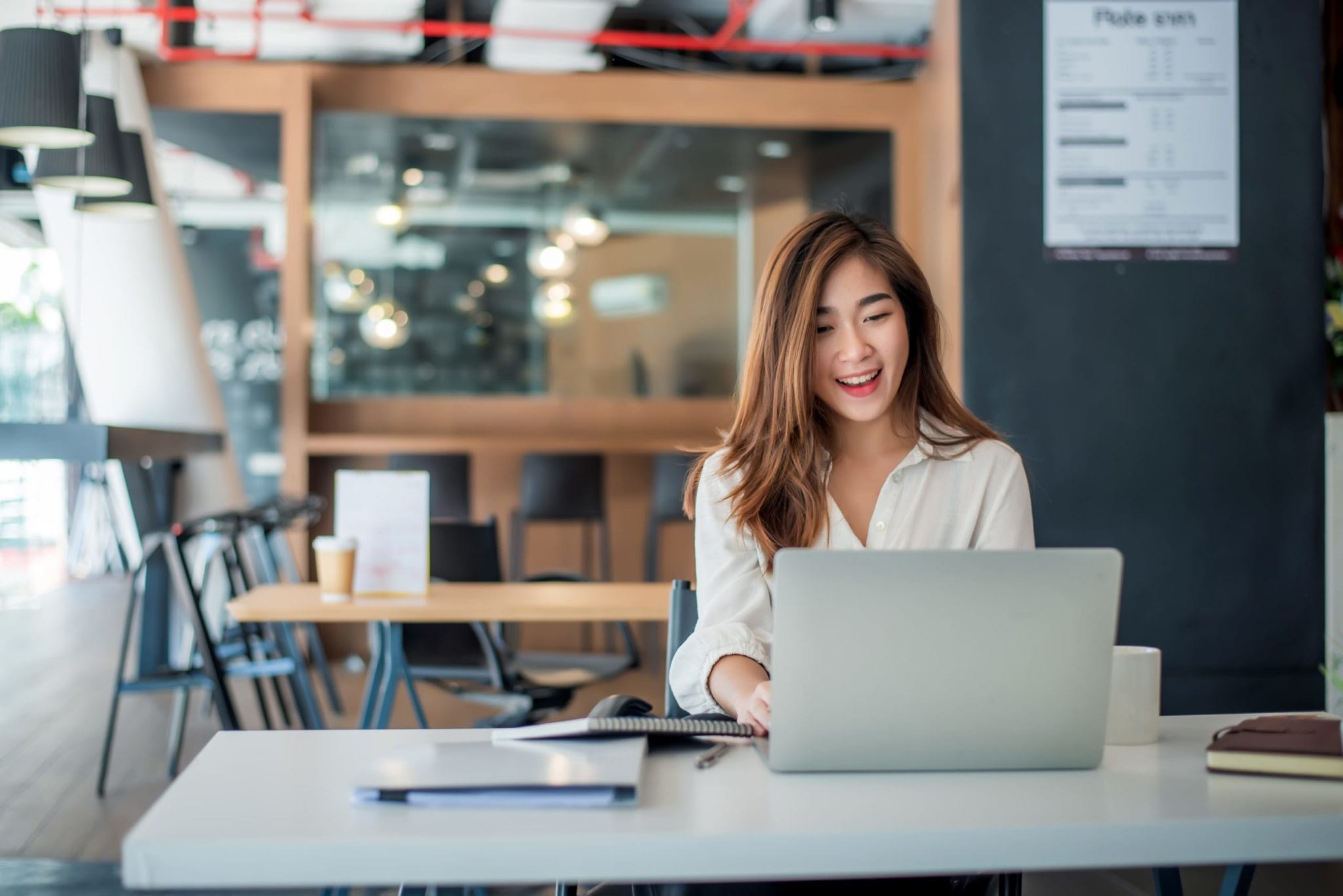 Asian Woman Working On Laptop In Office