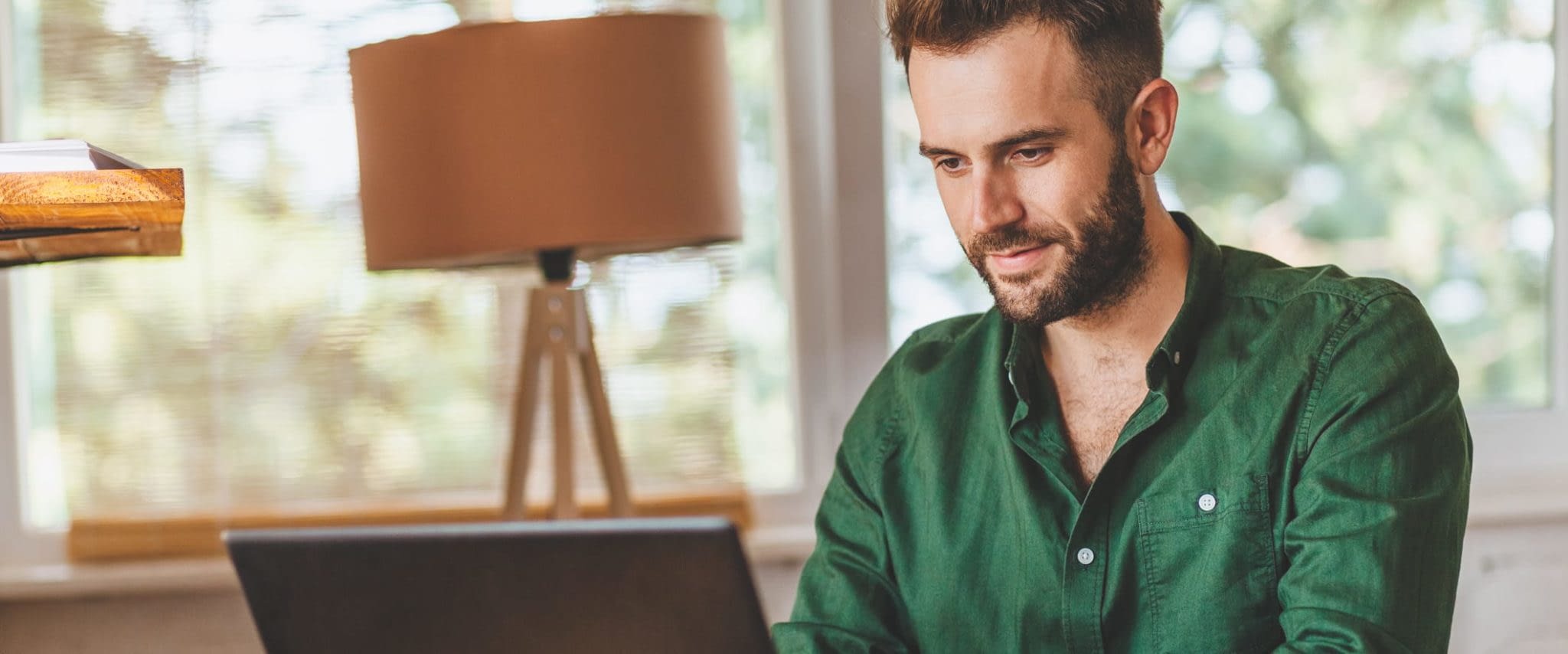 3 Things to Consider When Purchasing Buy:Sell Protection Insurance Young Man Working at Computer