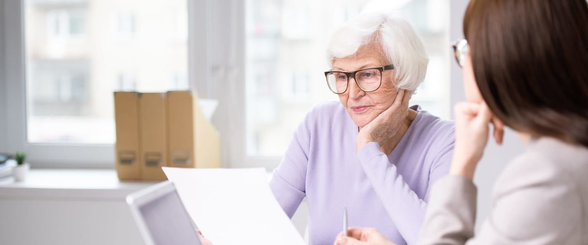 How to Prepare For Your “Welcome to Medicare” Visit Serious Senior Woman Reviewing Paperwork