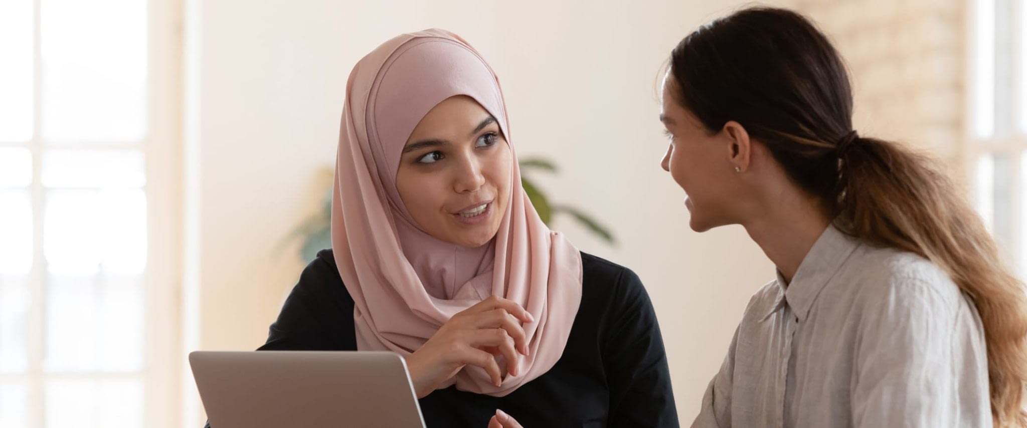 Two Young Women in Meeting