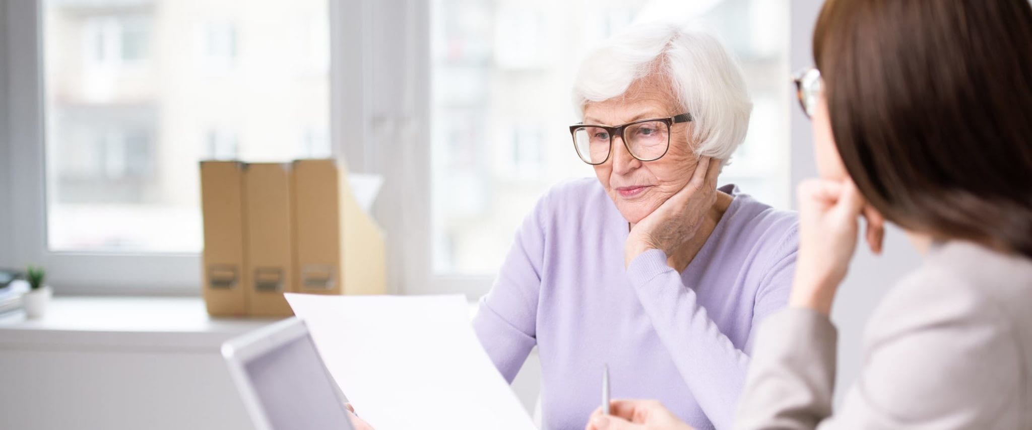 Serious Senior Woman Reviewing Paperwork