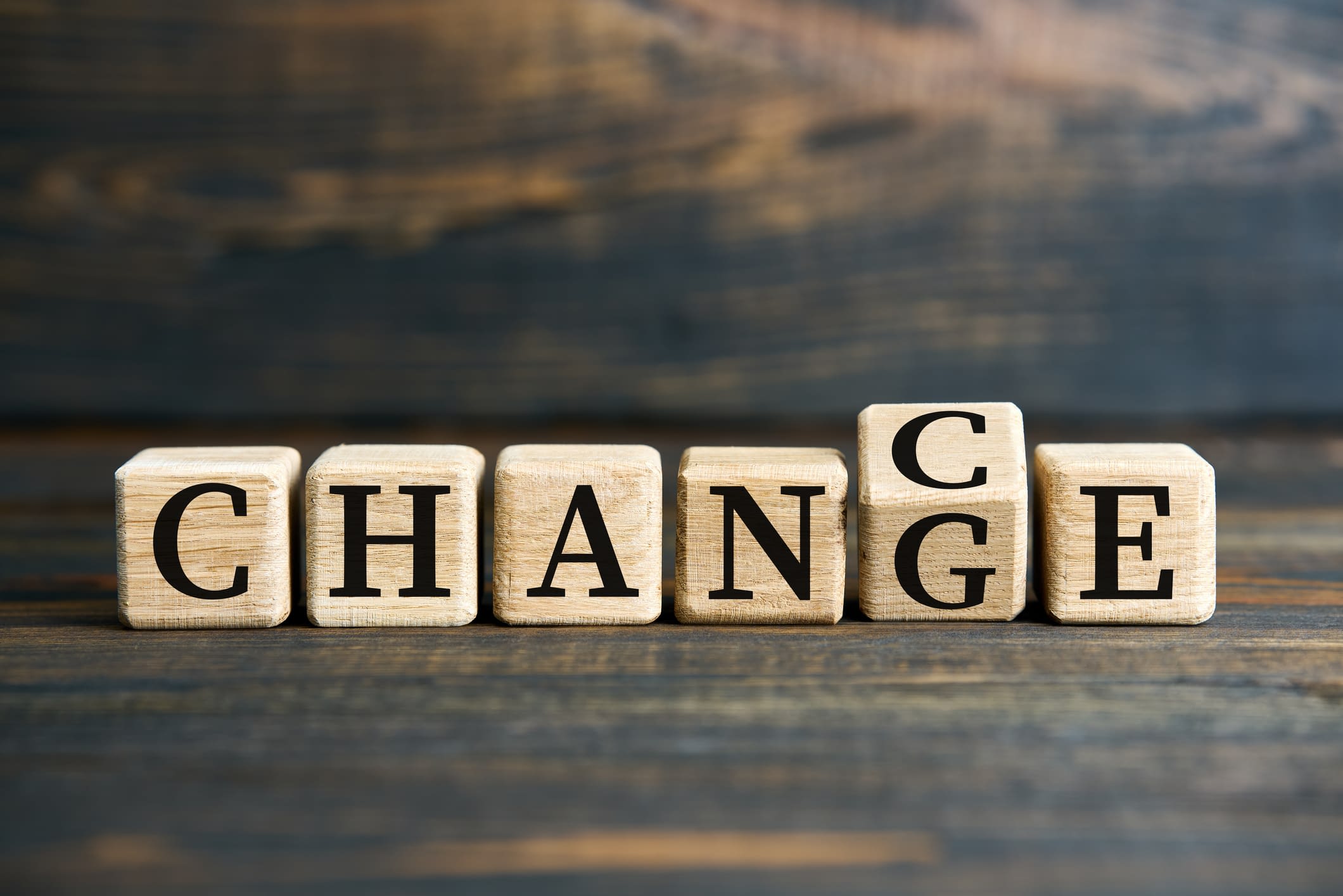 Flipping wooden cube blocks with CHANGE to CHANCE text Blocks reading chance and change