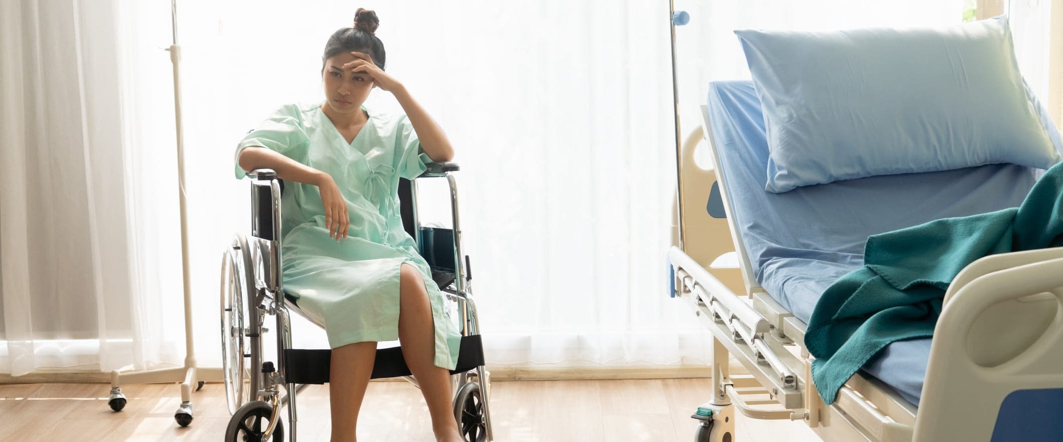 5 Medical Malpractice Insurance Myths Distressed Woman in Wheelchair in Hospital Room