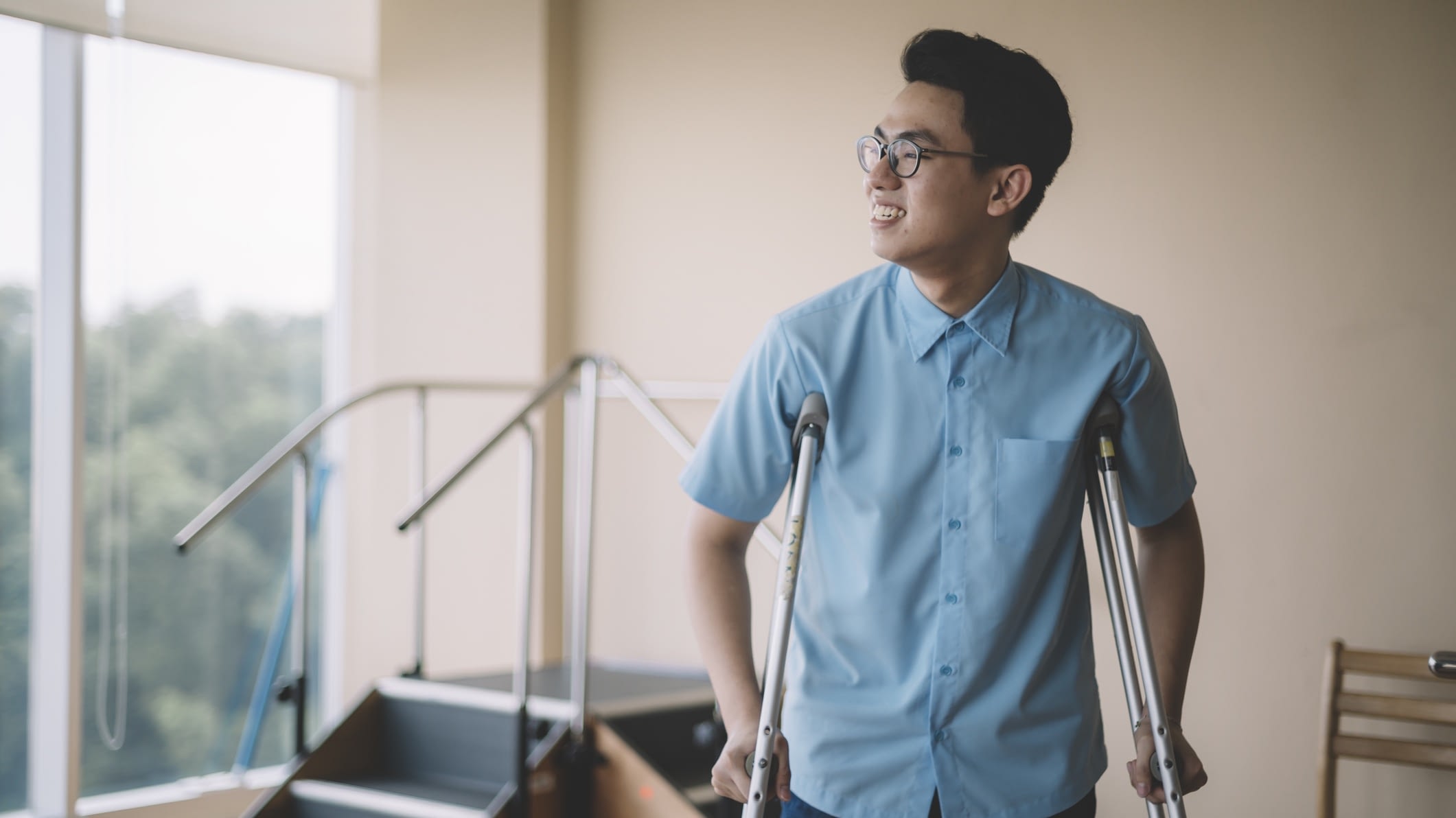 Asian man on crutches