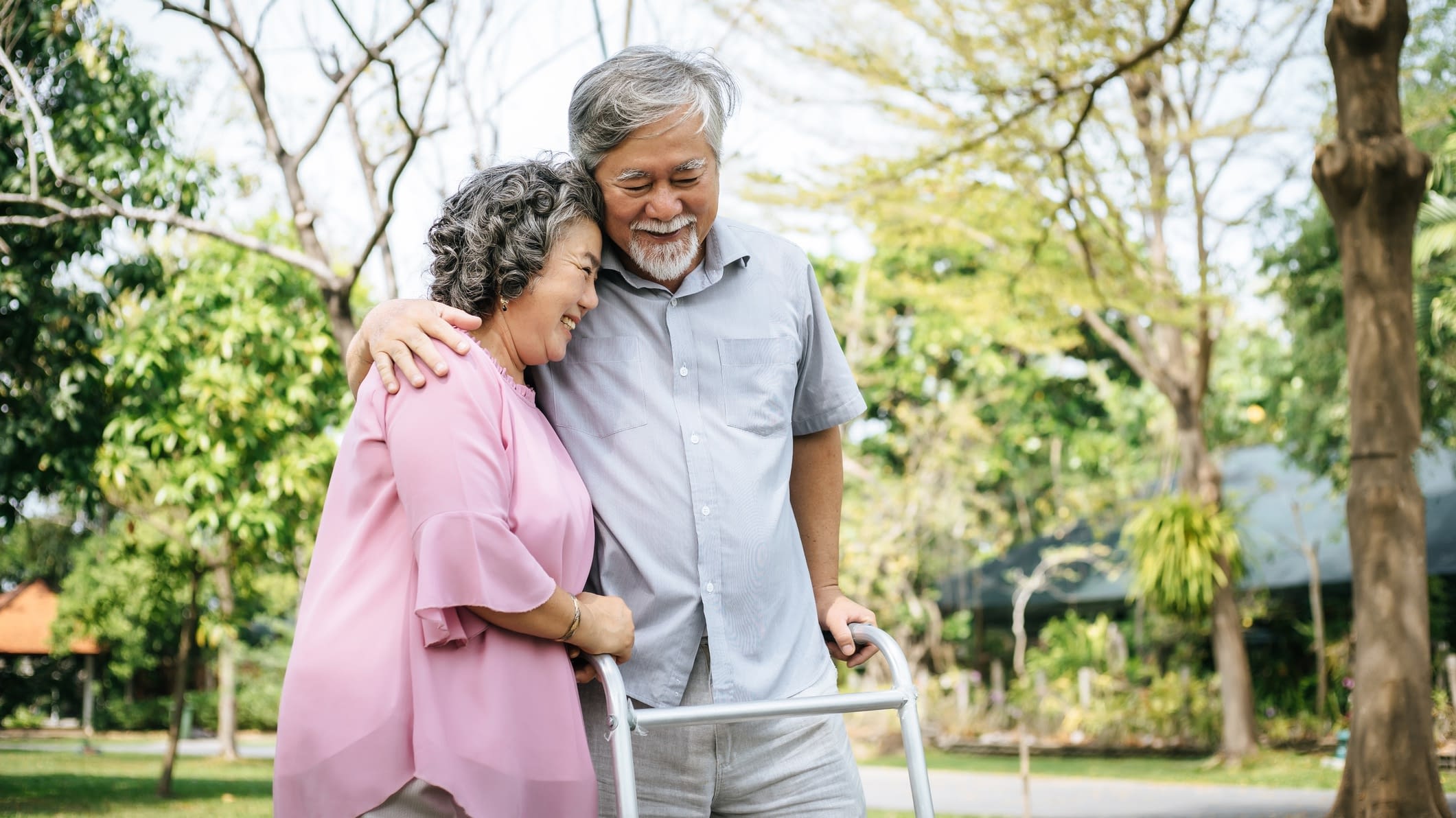 Happy couple outside walking on walker mature couple walking outside on waker