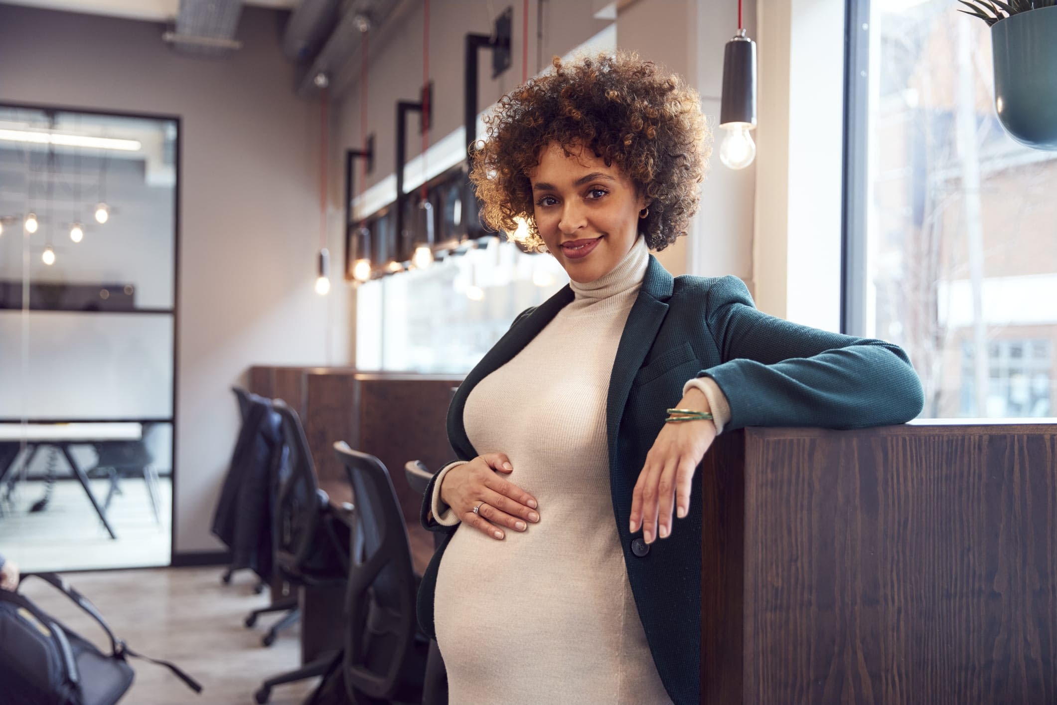 GettyImages-1279114426 Pregnant Businesswoman Holding Bump