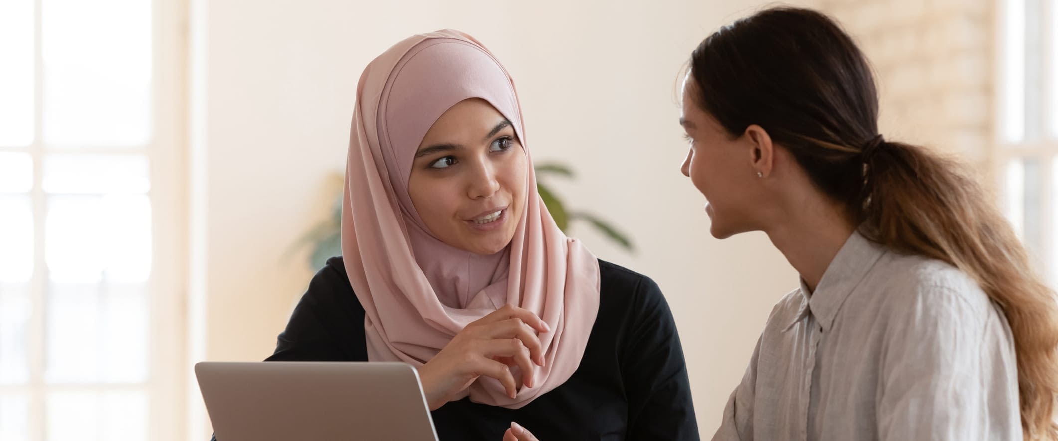 What is a High-Deductible Health Plan (HDHP)? Two Young Women in Meeting