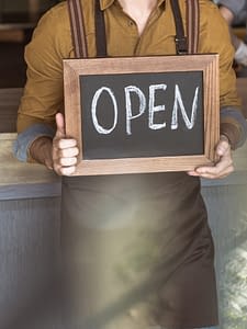 man holding open sign