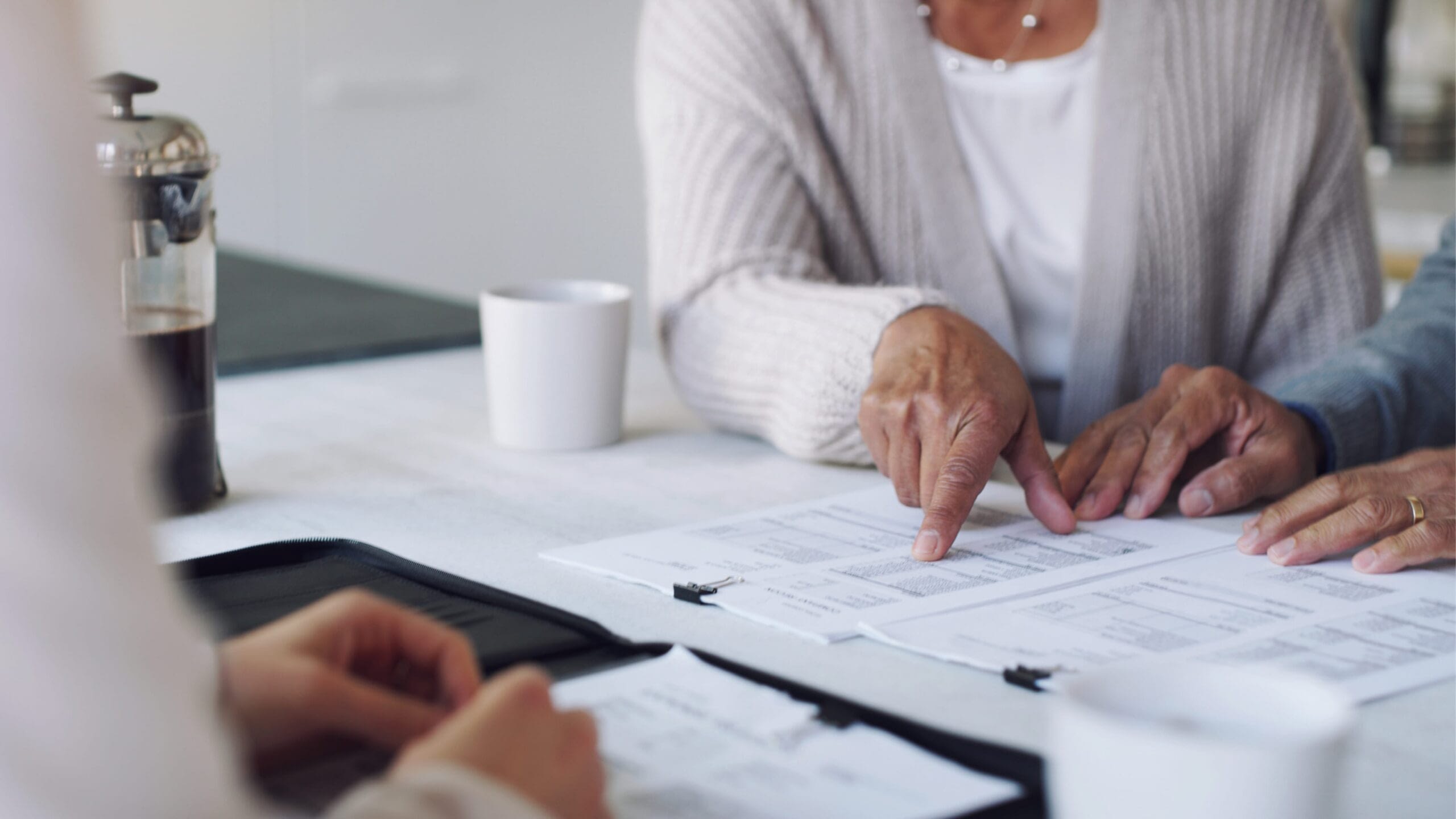 closeup of couple discussing life insurance plan with an agent