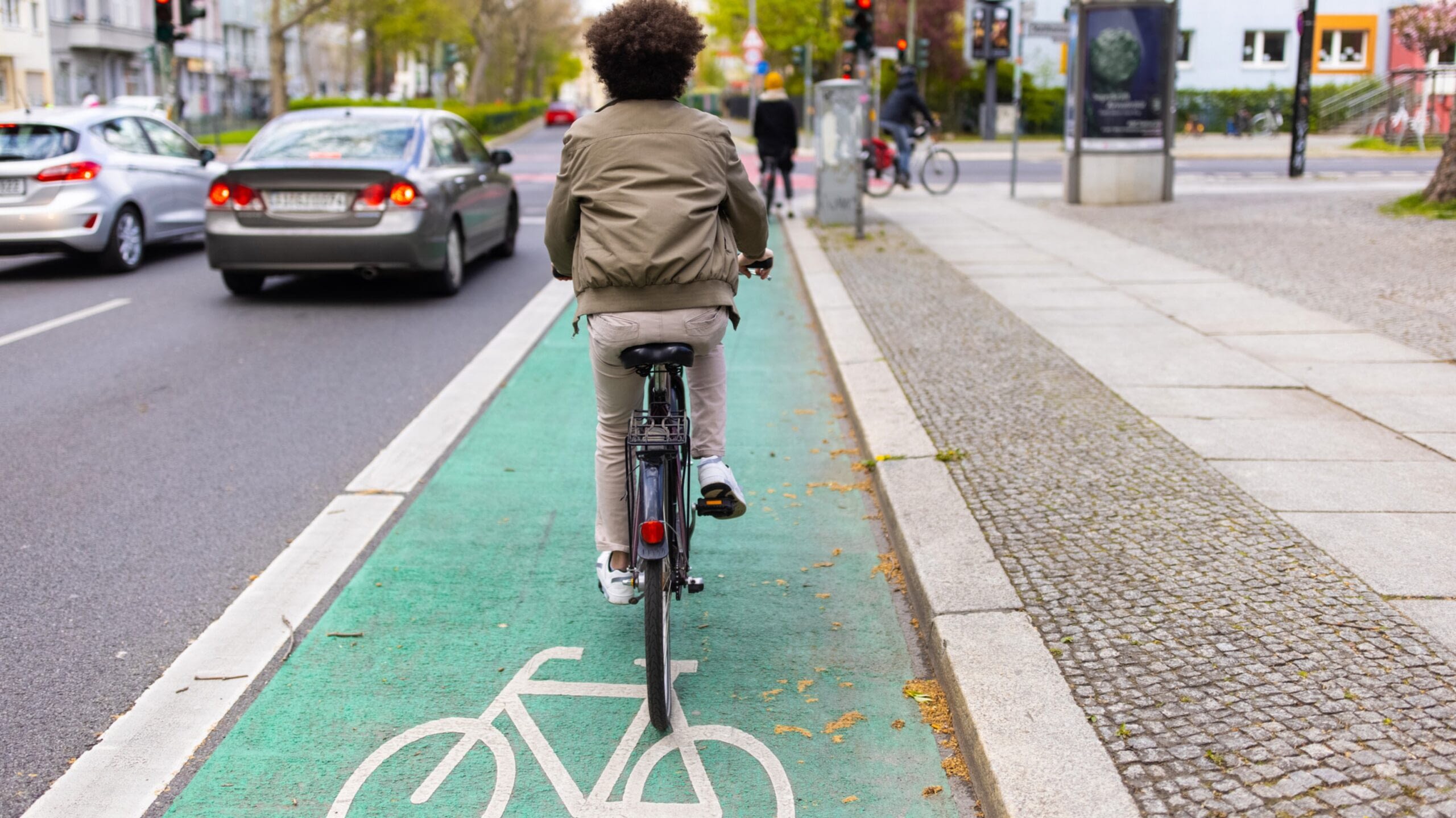 boy on bicycle lane in traffic