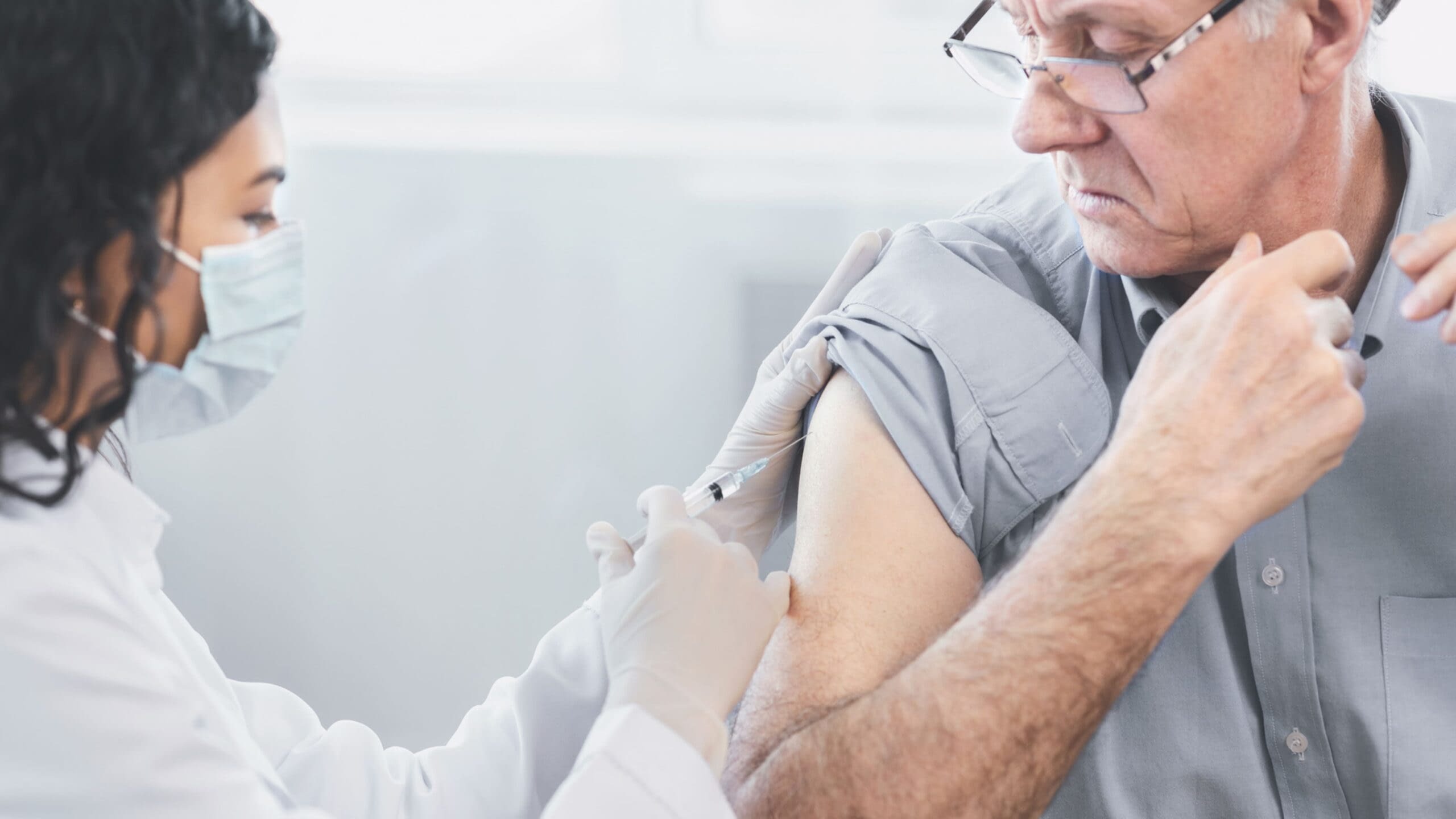 August 6th blog male senior citizen getting immunization shot from doctor