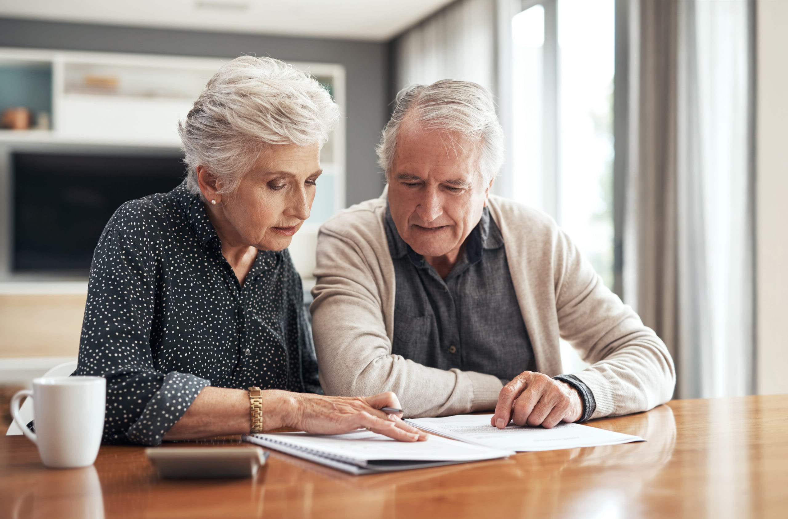 elder couple signing paperwork