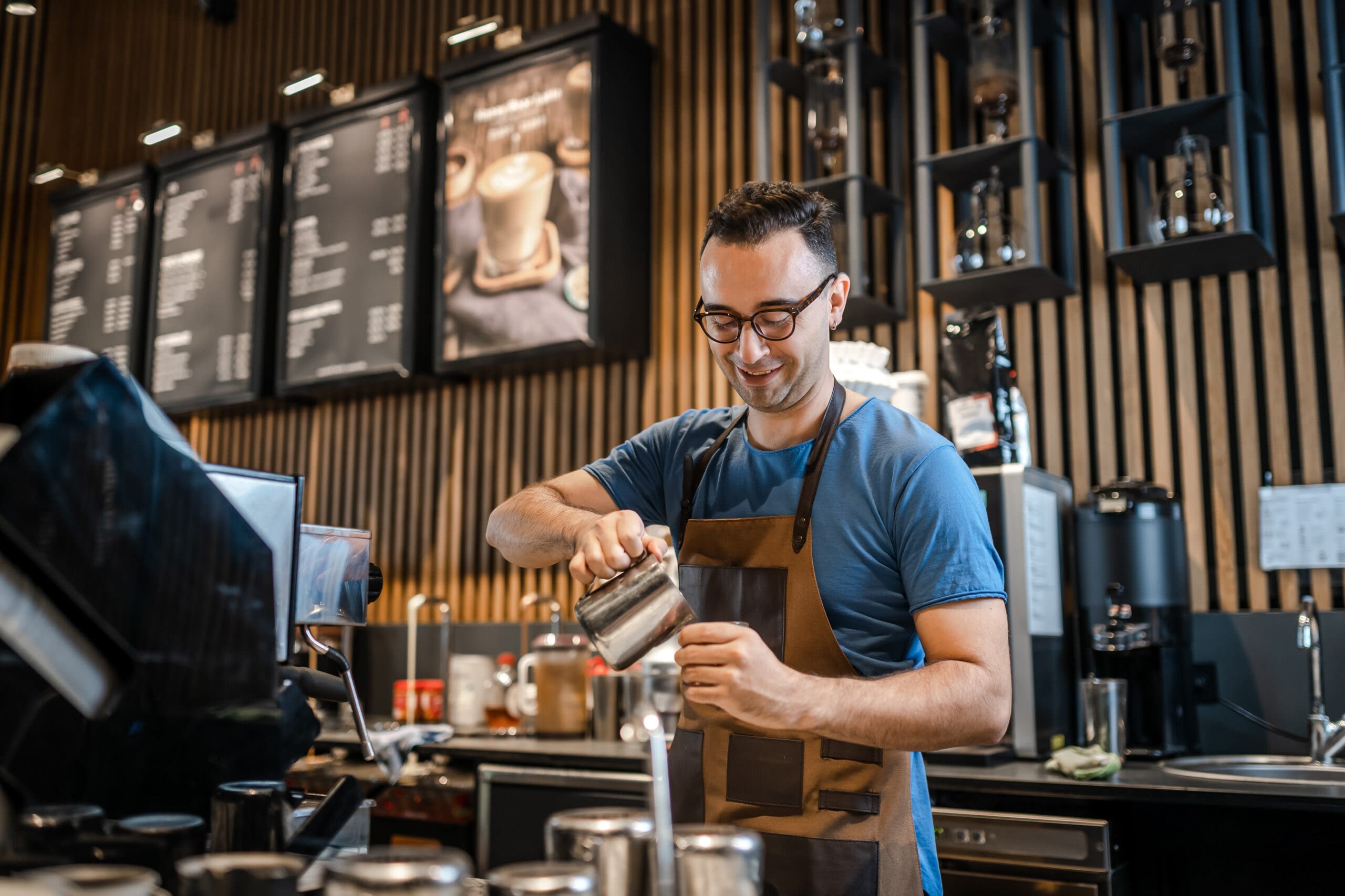 male barista making drink in business
