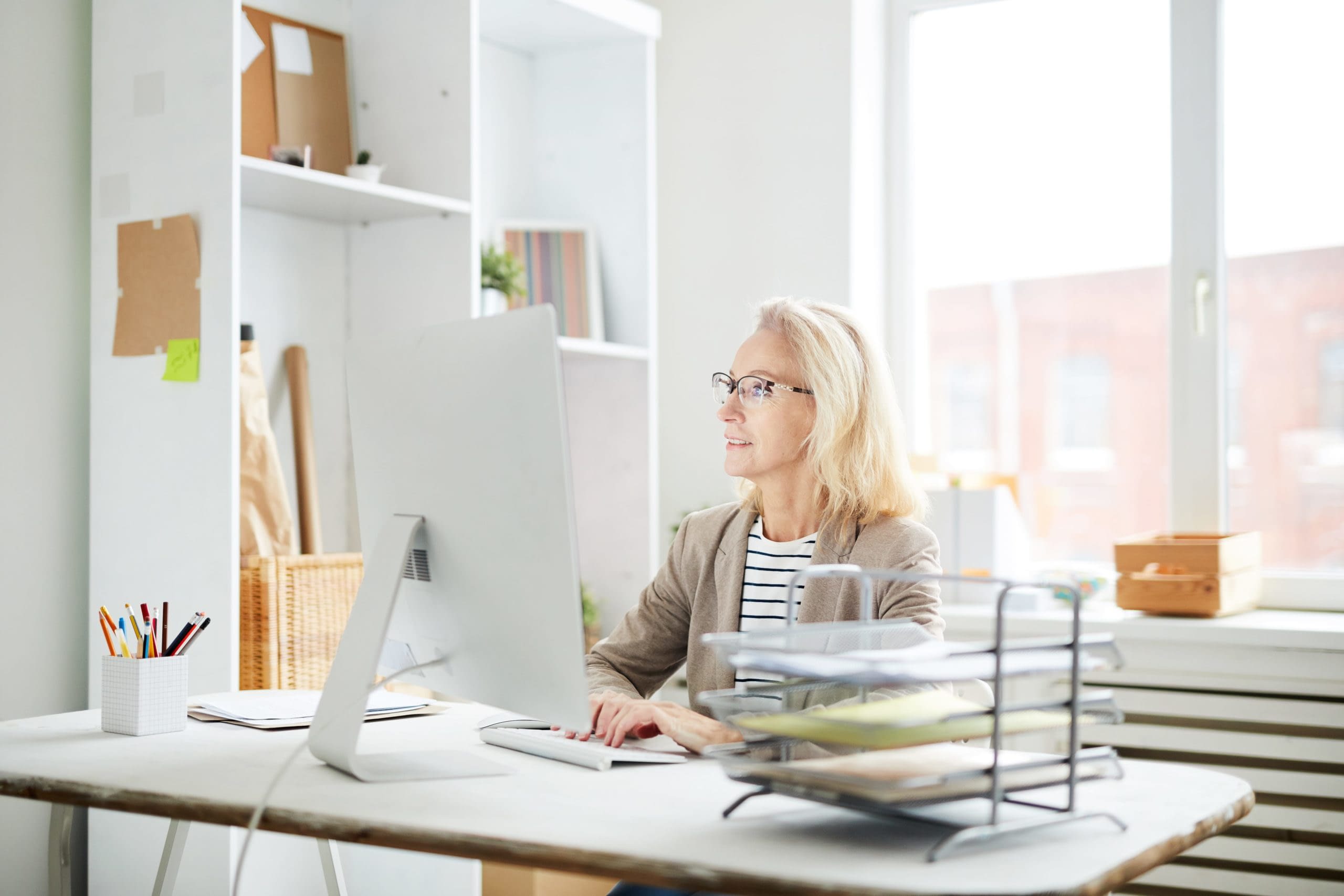 GettyImages-1129522925 woman using computer at desk
