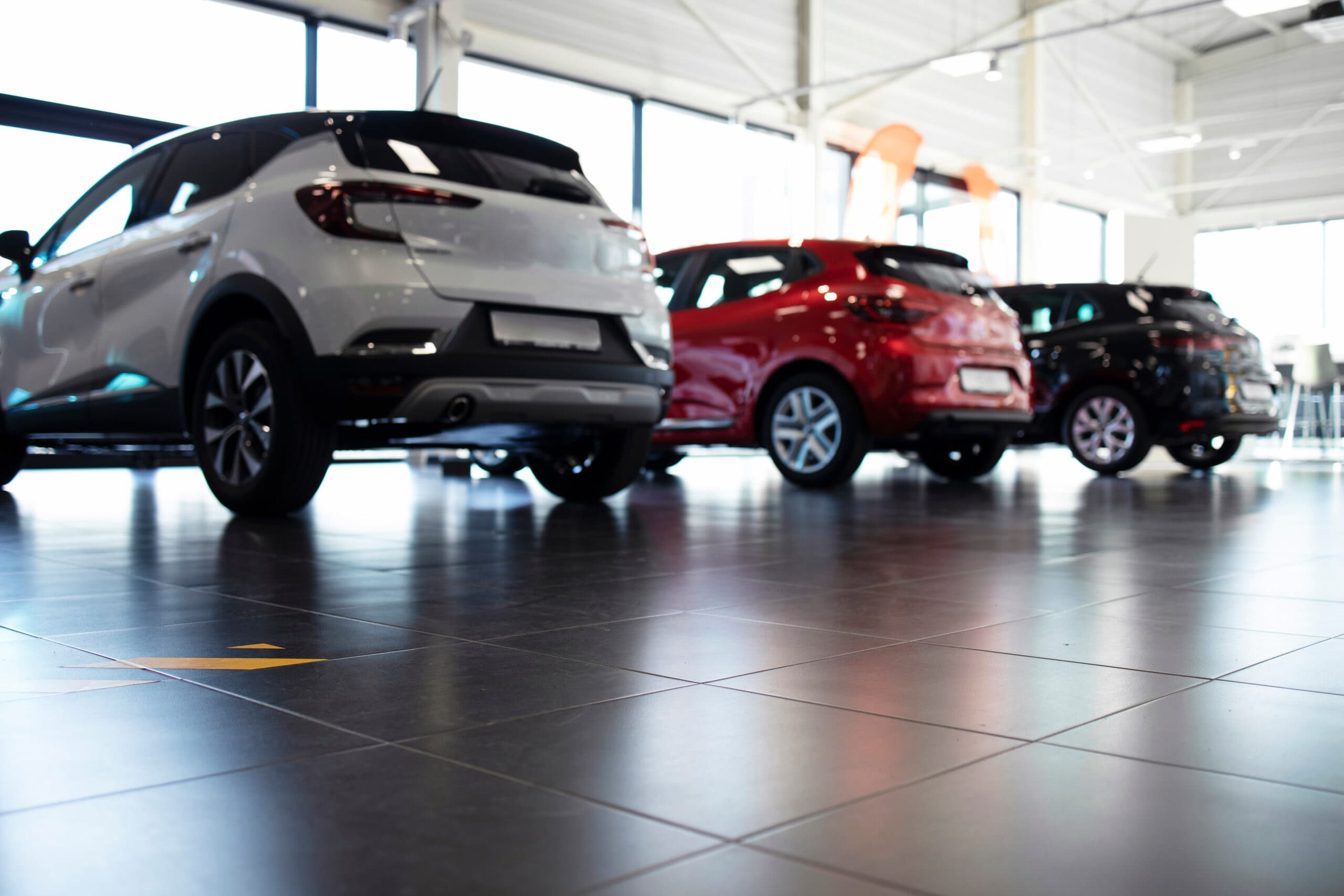 Car dealership showroom with vehicles for sale. Modern car purch