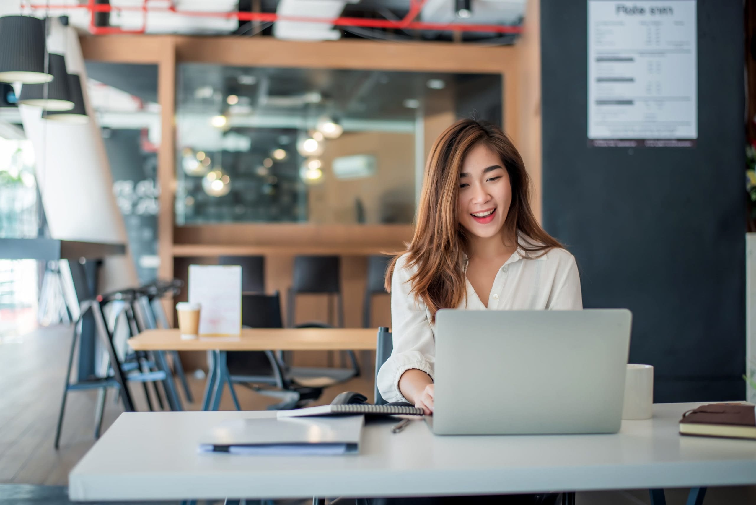 GettyImages-1278728777 Asian Woman Working On Laptop In Office
