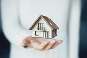 Home image in the palm of womans hand