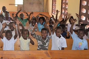 The Renard Foundation children with their hands rasied