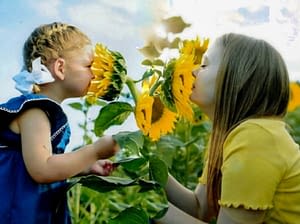 girls sniffing flowers