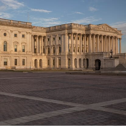 Capitol building under sunrise light