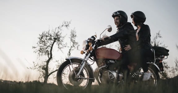 Two people riding a motorcycle