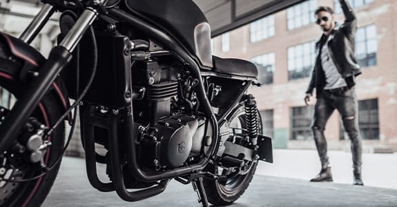 guy_opening_garage_door_with_a_motorcycle_in_the_garage_575x300