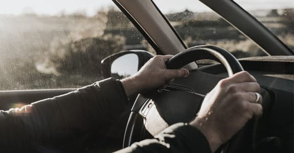 two_hands_on_a_steering_wheel_575x300