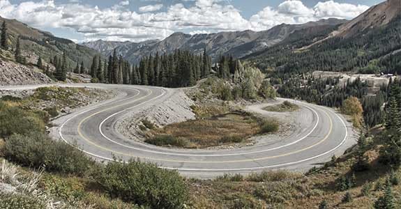 road_going_through_hills_575x300