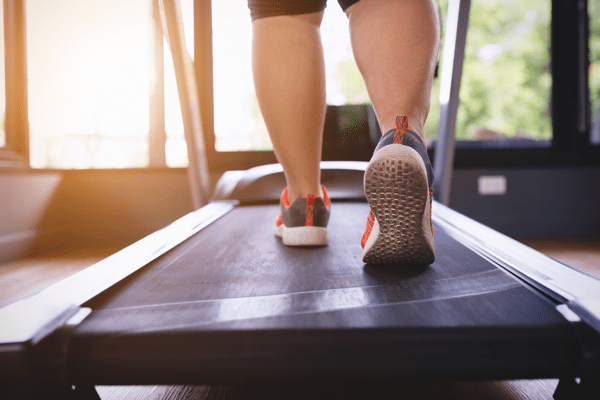 Workout woman walking on a treadmill