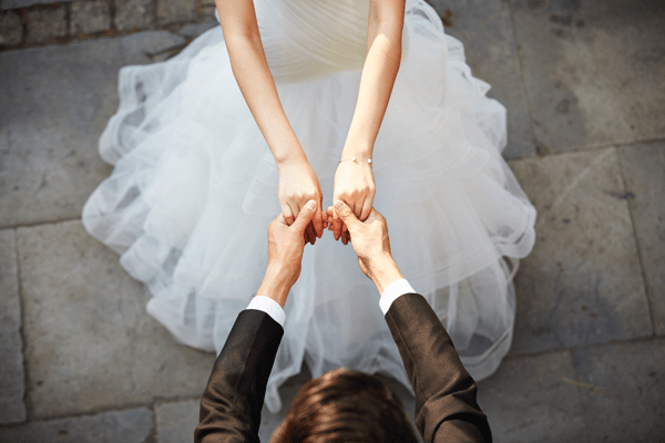 bride and groom holding hands