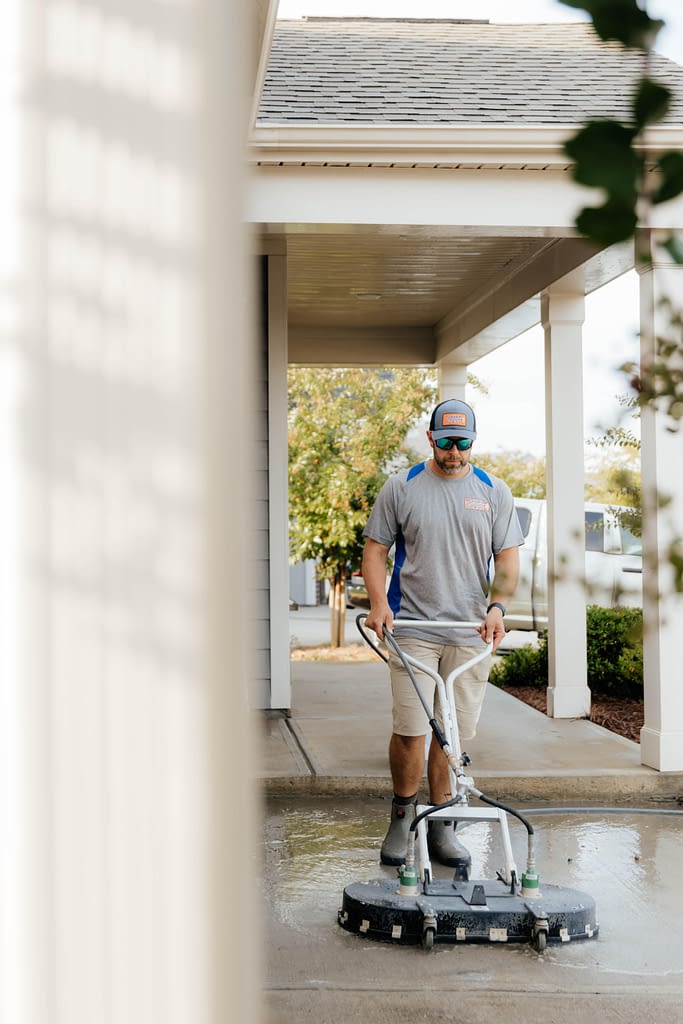 Man cleaning sidewalk
