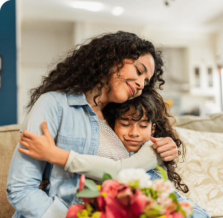 child embracing mother at home