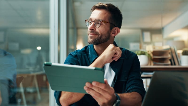 Business Insurance 82726 Businessman reviewing insurance policies on tablet
