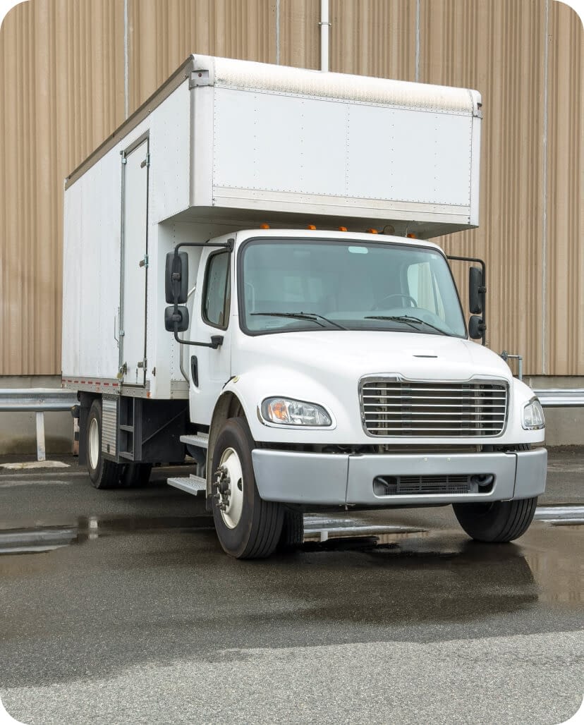 white-box-truck-parked-outside-warehouse