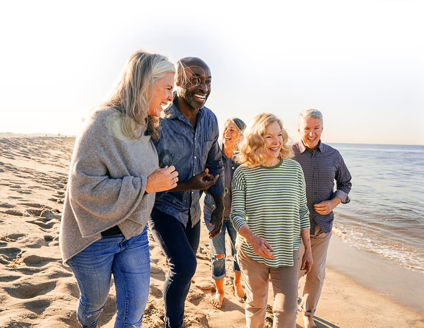 friends having a great time walking along the shore