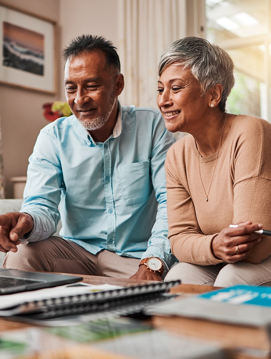 Middle aged couple looking at a computer