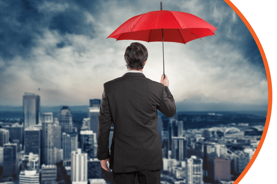 man in a black suit holding a red umbrella while staring out to a city skyline