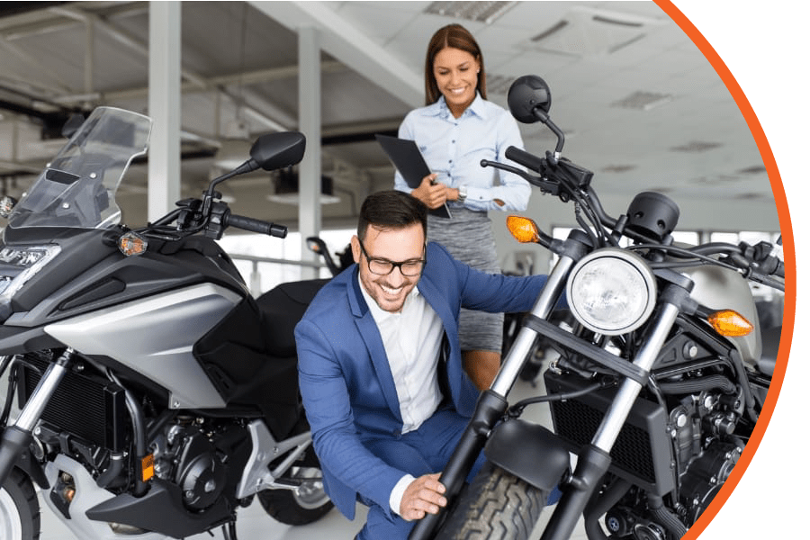 woman and man at dealership looking at motorcycles