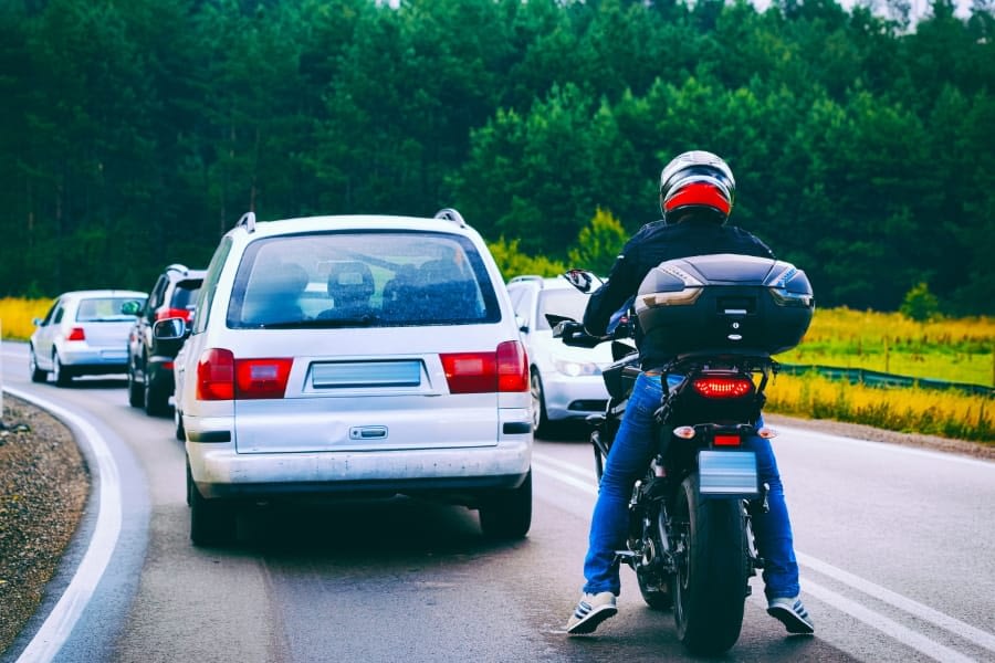 Motorcycle behind cars driving