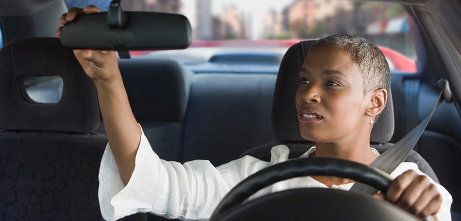 2022_eriesenseblog-iihs_lg-1 Woman Adjusting Rearview Mirror