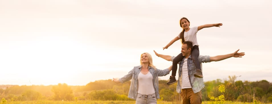 Young happy family in a field Young Happy Family In a Field