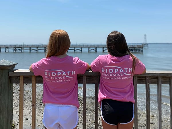 Girls on a pier wearing Ridpath shirts