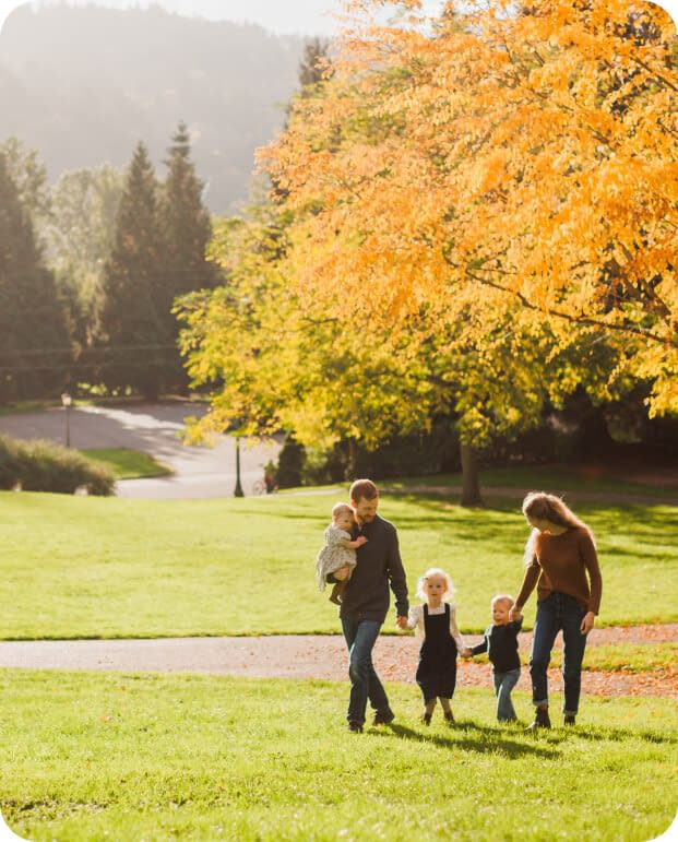 two adult parents and three children at park