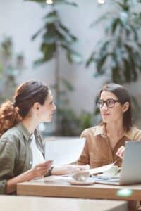 Two young businesswomen discussing buy /sell protection.